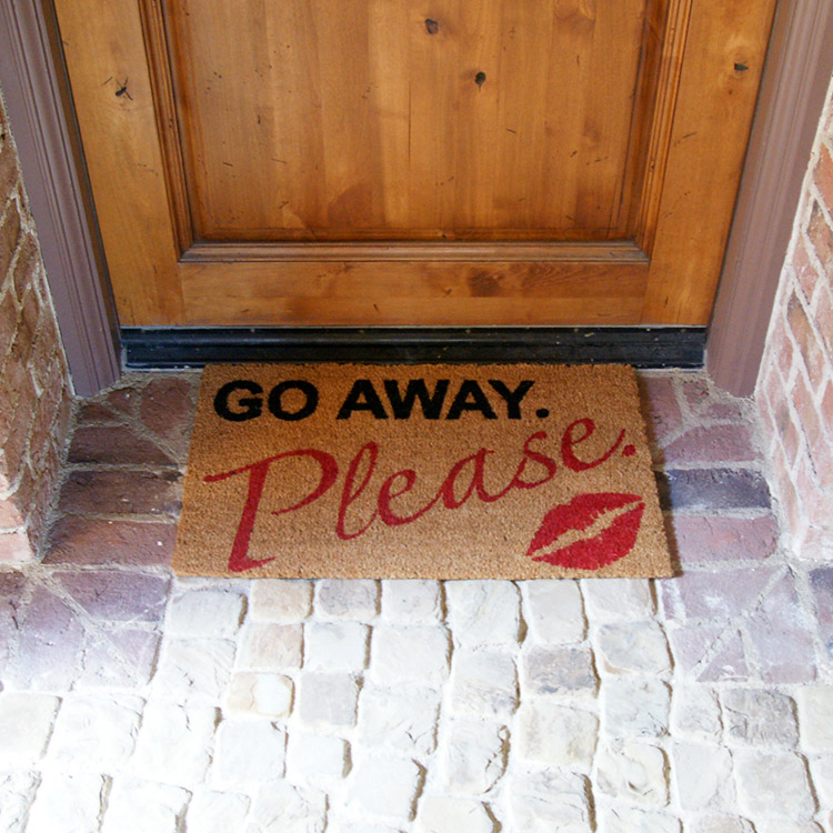 Go away please polite kiss welcome mat in front of a door