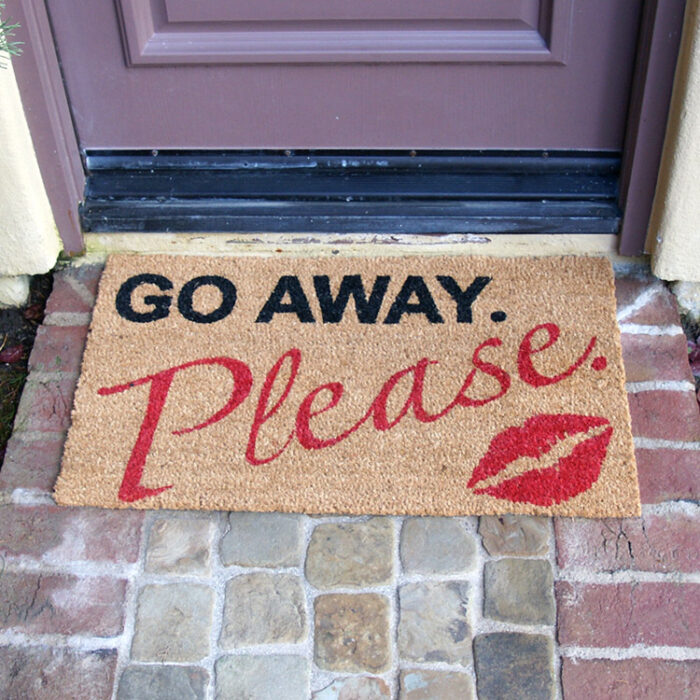 A polite kiss go away please welcome mat in front of door