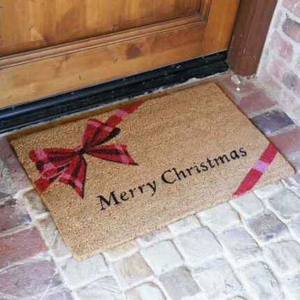 Sign saying merry christmas with a present design on the brown mat