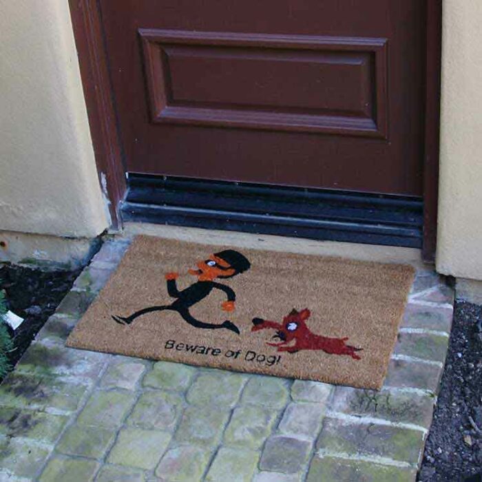 Beige beware of dog welcome mate in front of brown door