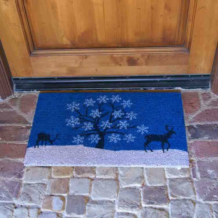 Holiday Doormats with a Blue Sky tree and a pair of deers in Mind in front of brown door