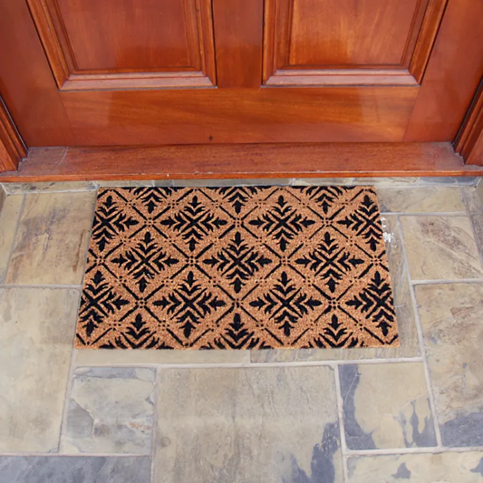 Classic Fleur de Lis French Mat with diamond patterns in front of door