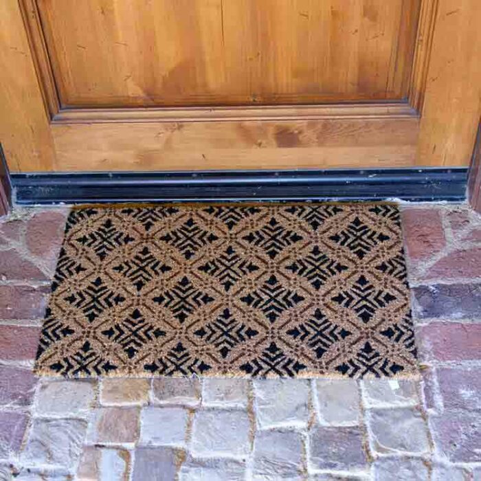 Classic Fleur de Lis French Mat with diamond patterns in front of door