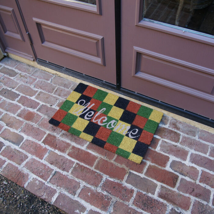 Welcome mat with autumn colors in checkerboard pattern
