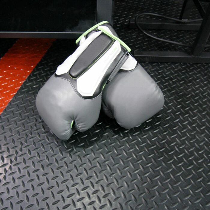 diamond plate underneath a pair of gray boxing gloves