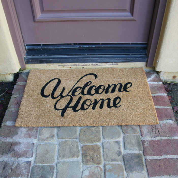 Greetings from your humble abode! welcome home doormat in front of door