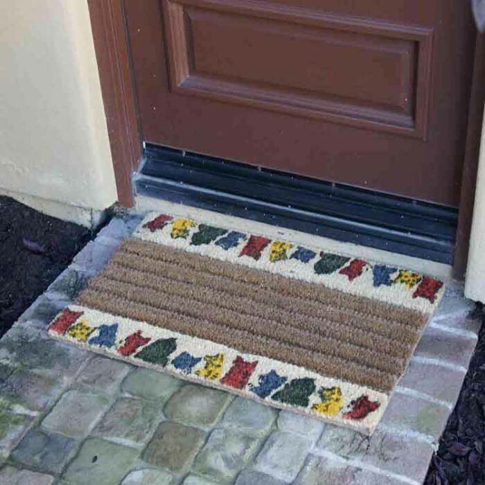 Decorative Doormat with colorful cats at top & bottom edges in front of door