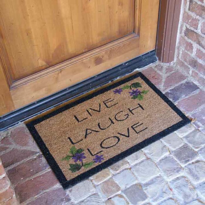 Brown live laugh love mat in front of brown door