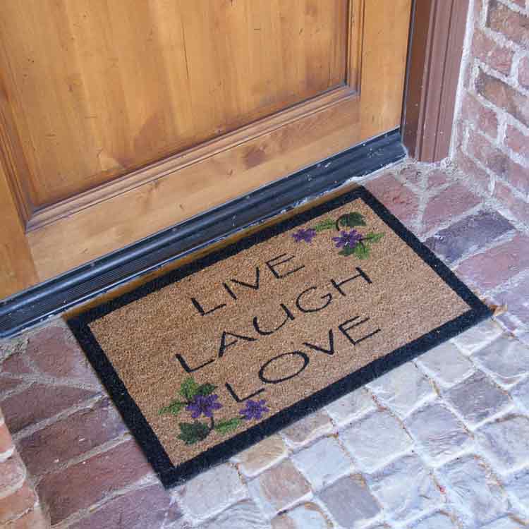 Brown live laugh love mat in front of brown door