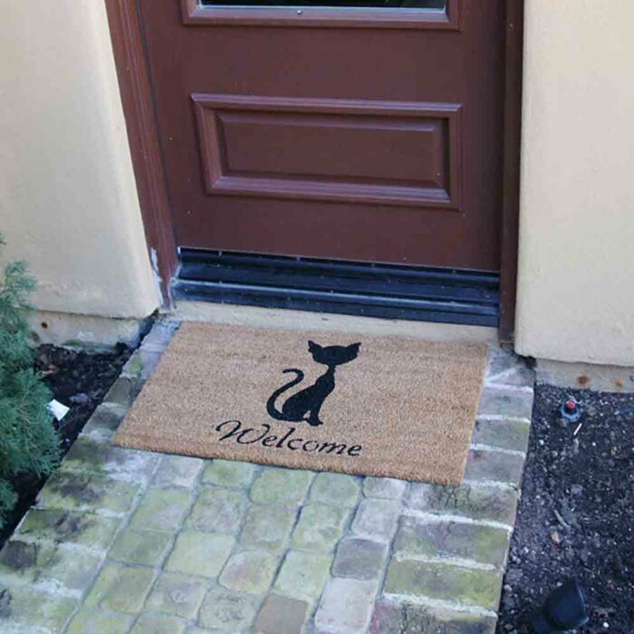 Welcome caption black text with a cat in middle of brown mat