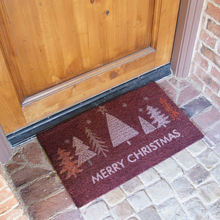 Red Christmas Tree Doormat with white text saying merry christmas in front of a door mat