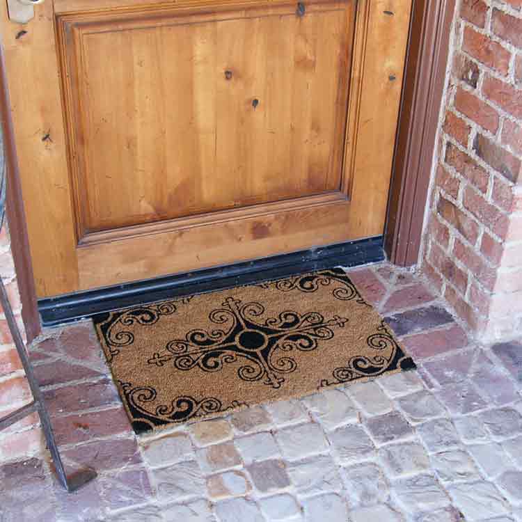 Traditional Fleur de Lis French Mat in front of brown door