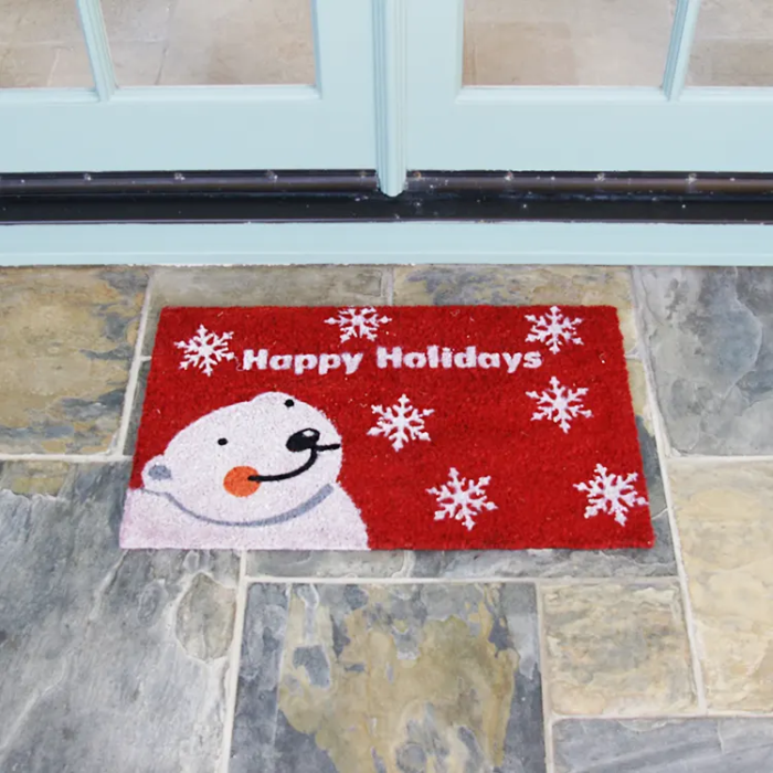 Happy Holidays written in white text with a white bear next to it and snowflakes