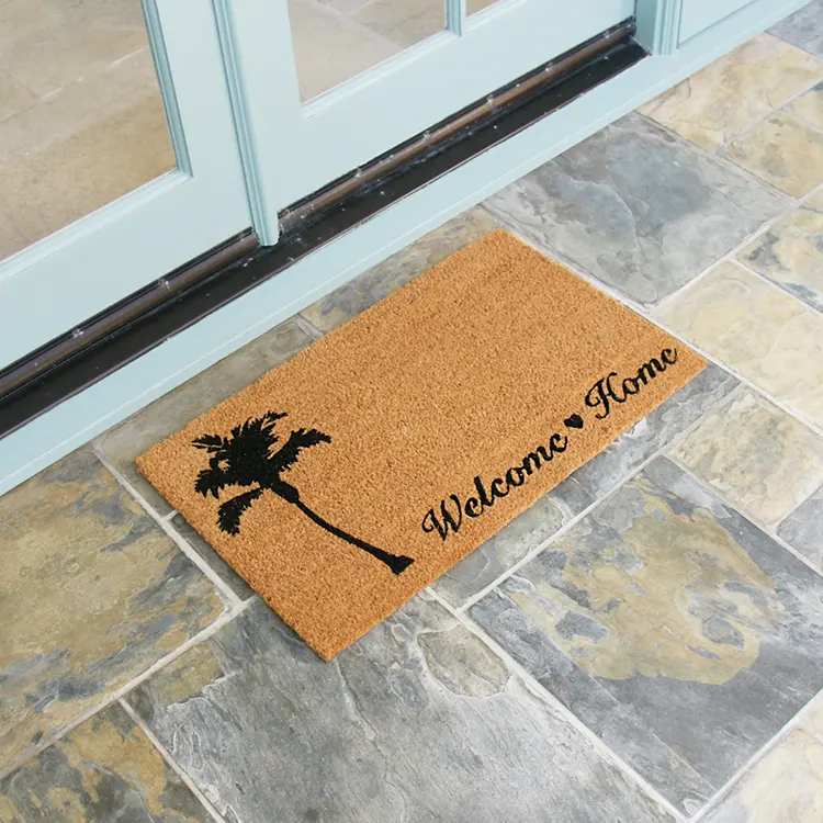 Beach themed welcome home mat with picture of tree in front of white double doors