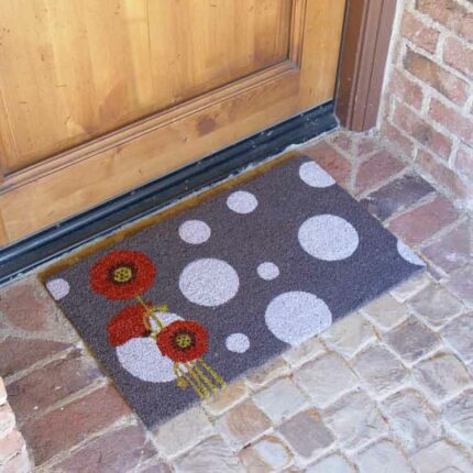 Eco-Friendly Doormat with red flowers & white bubbles design in front of brown door