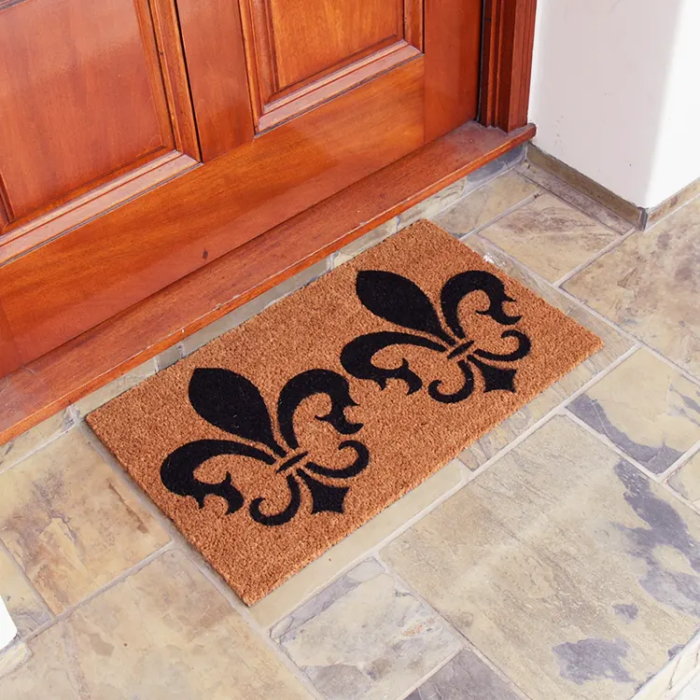 The Clovis Legend Inspired French Mat in Brown and Black in front of a red door