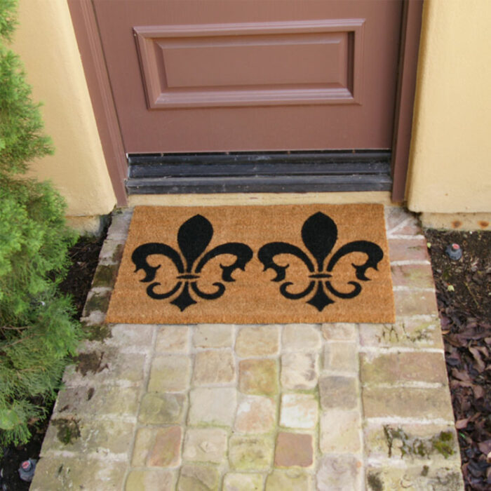 The Clovis Legend Inspired French Mat in Brown and Black in front of a dark brown door