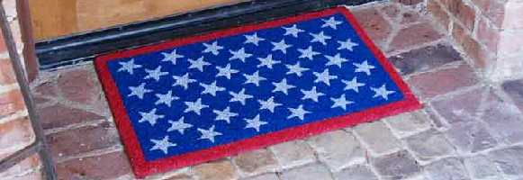 Red, white, and blue Patriotic doormat representing the American flag in front of light brown door