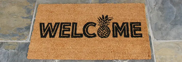 welcome to the luau pineapple in front of door